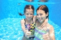 Kids swim in pool underwater