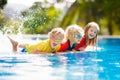 Kids in swimming pool. Children swim. Family fun