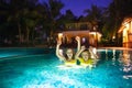 Kids in swimming pool at night Royalty Free Stock Photo