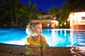 Kids in swimming pool at night Royalty Free Stock Photo