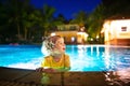 Kids in swimming pool at night Royalty Free Stock Photo