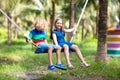 Kids on swing. Playground in tropical resort Royalty Free Stock Photo