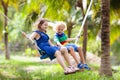 Kids on swing. Playground in tropical resort Royalty Free Stock Photo