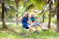 Kids on swing. Playground in tropical resort Royalty Free Stock Photo