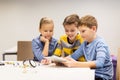 Kids with tablet pc programming at robotics school Royalty Free Stock Photo