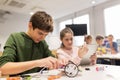 Kids with tablet pc programming at robotics school Royalty Free Stock Photo