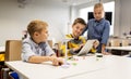 Kids with tablet pc programming at robotics school Royalty Free Stock Photo