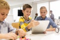 Kids with tablet pc programming at robotics school Royalty Free Stock Photo