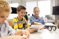 Kids with tablet pc programming at robotics school Royalty Free Stock Photo