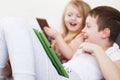 Kids with tablet and smartphones in bed at home. Distance learning online education. children playing with gadgets Royalty Free Stock Photo