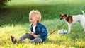 Kids tantrums during walk. Upset child boy at the summer park. Childhood. Sad kid walking with dog Royalty Free Stock Photo