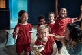 Kids team and female coach posing with won trophy. Children team sport Royalty Free Stock Photo