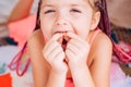 Kids teeth. Smiling girl holding missing tooth. Funny face close up.