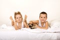 Kids with their kitten on the bed Royalty Free Stock Photo