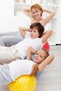 Kids with their mother doing gymnastic exercises