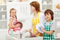Kids and their mother washing dishes