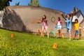 Kids throw hula hoops to target, competitive game