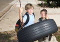 Kids and tire swing Royalty Free Stock Photo