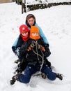 Kids tobogganing in the snow Royalty Free Stock Photo