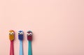 Kids toothbrushes of different colors on a pink background. Teeth and oral hygiene for children