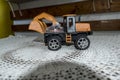 Kids toy - Mini excavator in the Kozya Sten hut. The toy is fun