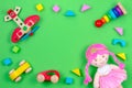 Kids toys background frame with wooden plane, cars, baby stacking rings pyramid, stuffed doll and colorful blocks on Royalty Free Stock Photo