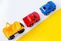 Kids toys cars on white and yellow background. Top view. Flat lay. for text