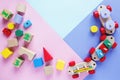 Kids toys: pyramid, wooden blocks, xylophone, train on white wooden background. Top view. Flat lay.