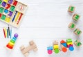 Kids toys: pyramid, wooden blocks, xylophone, train on white wooden background. Royalty Free Stock Photo