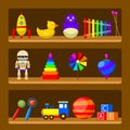 Kids toys on wood shop shelves isolated on background. Set of vintage rubber toy beanbag, baby rattle, robot, rocket, ball, truck Royalty Free Stock Photo