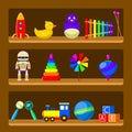 Kids toys on wood shop shelves isolated on background. Set of vintage rubber toy beanbag, baby rattle, robot, rocket, ball, truck Royalty Free Stock Photo
