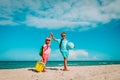 Kids travel on beach, boy and girls with backpack, globe and toys at sea Royalty Free Stock Photo