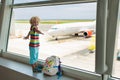 Kids travel and fly. Child at airplane in airport Royalty Free Stock Photo