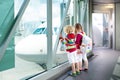 Kids travel and fly. Child at airplane in airport Royalty Free Stock Photo