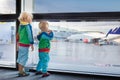 Kids travel and fly. Child at airplane in airport Royalty Free Stock Photo