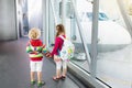 Kids travel and fly. Child at airplane in airport Royalty Free Stock Photo