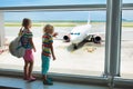 Kids travel and fly. Child at airplane in airport Royalty Free Stock Photo