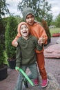 Kids in trendy hats and hoodies having fun in park, fall vibes, autumn beauty style, child fashion