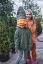 Kids in trendy hats and hoodies having fun in park, fall vibes, autumn beauty style, child fashion