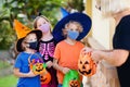 Kids trick or treat. Halloween in face mask