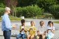 Kids Using Gadgets during Outdoor Lesson