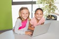 Kids using laptop in library Royalty Free Stock Photo