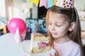 Kids virtual birthday,home party.Girl eating piece of cake.Online conference,video call in laptop,computer.Friends on screen, Royalty Free Stock Photo