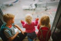 Kids waiting for plane in airport, family travel