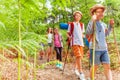 Kids walk with hiking poles among fern Royalty Free Stock Photo