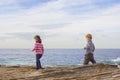 Kids walking on beach rocks Royalty Free Stock Photo