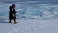 Kids walking ona frozen lake Baikal, Russia