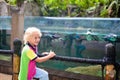 Kids watch penguin at zoo. Child at safari park