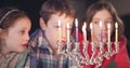 Kids watching hanukka candles burning