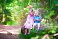 Kids watching a hedgehog in the forest